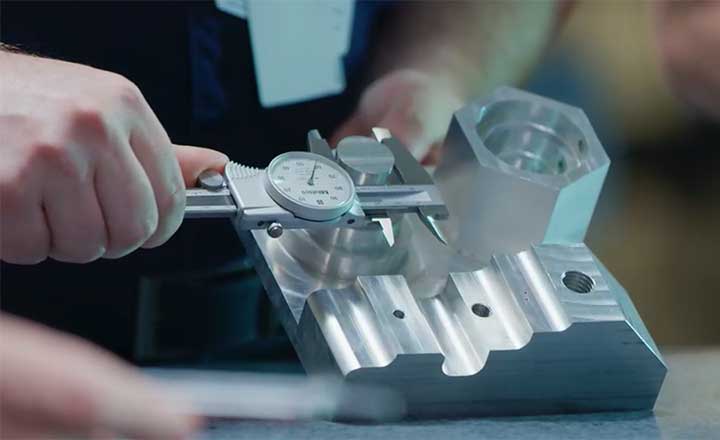 Close-up image of a man measuring a piece of equipment